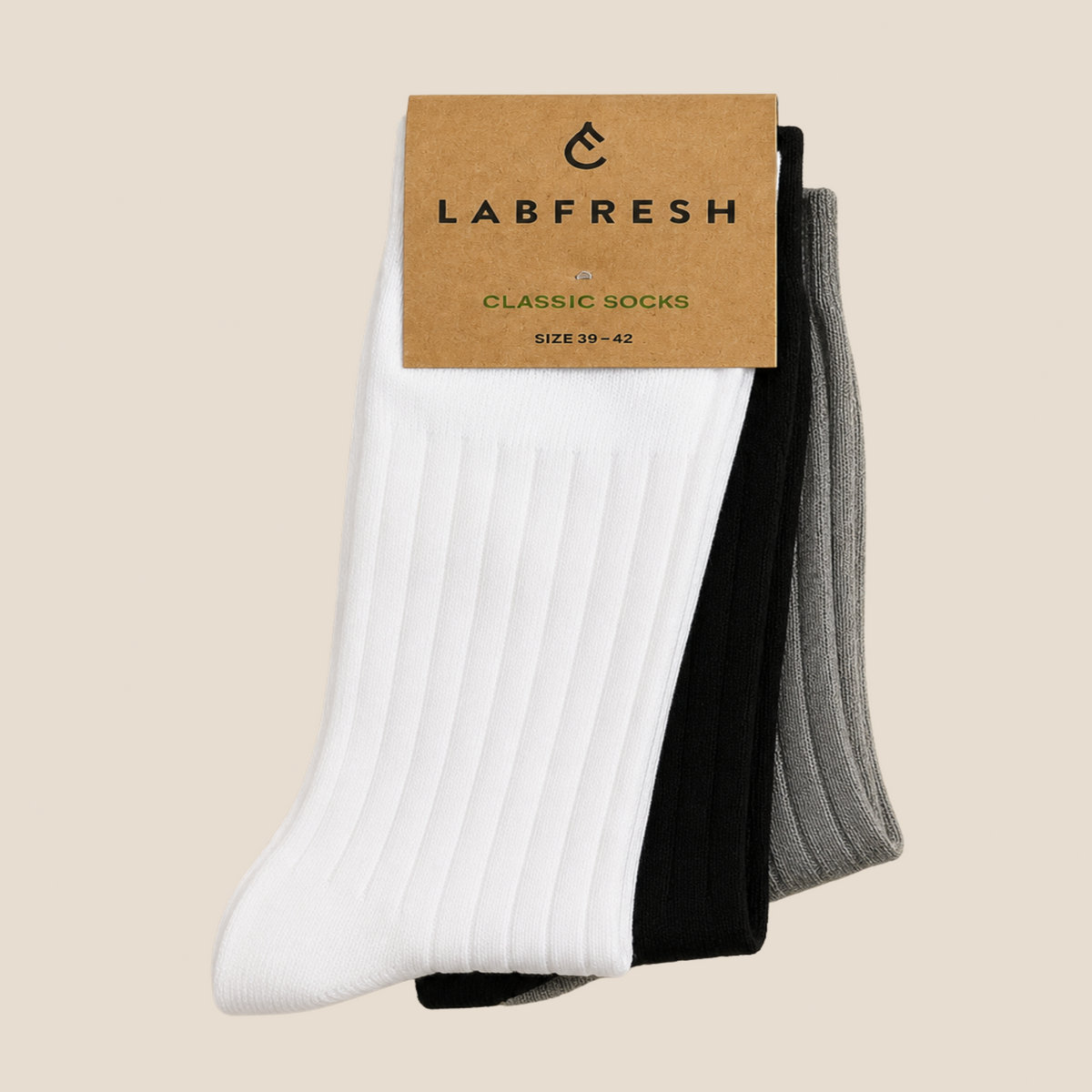 A three-pack of ribbed crew socks by LABFRESH, featuring white, black, and heather gray colors, packaged with a brown kraft paper header card on a solid beige background.