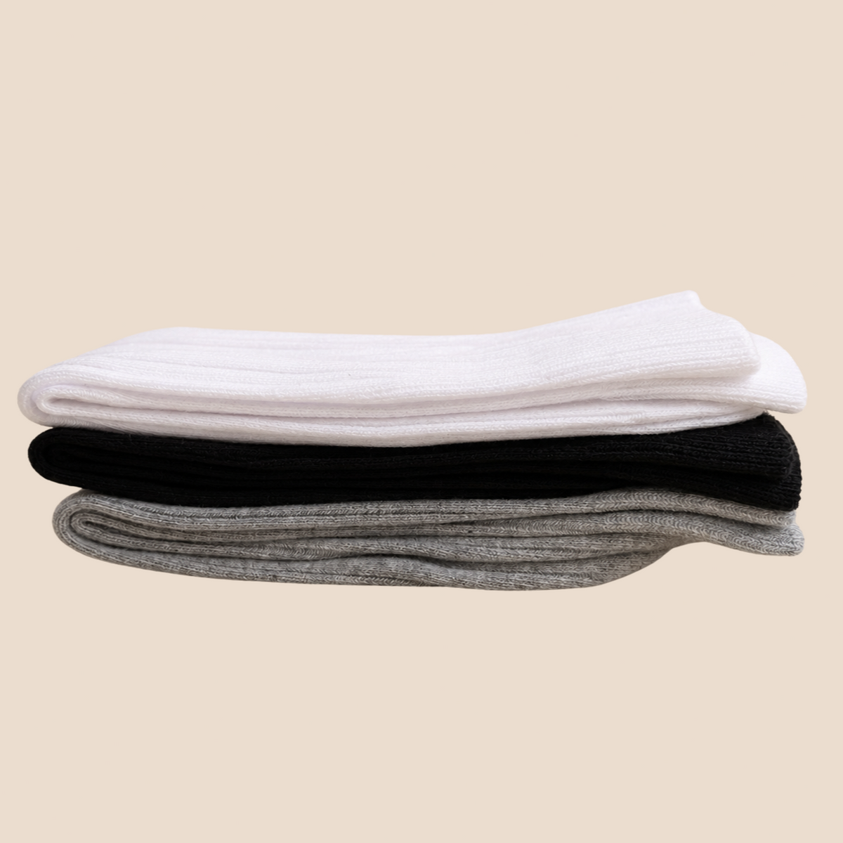 Three folded ribbed knit socks stacked on a light beige background, shown in white, black, and heather gray.